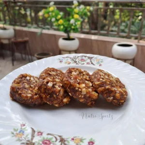 An image of dry fruit burfi on a plate.