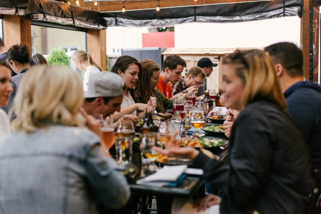 An image showing people eating together and connecting with each other