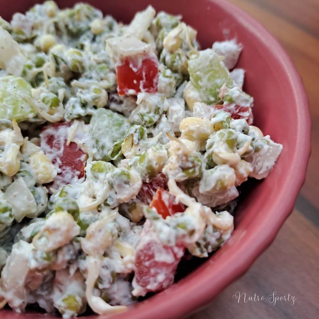 An image of moong dal sprouts salad- creamy version in a bowl.