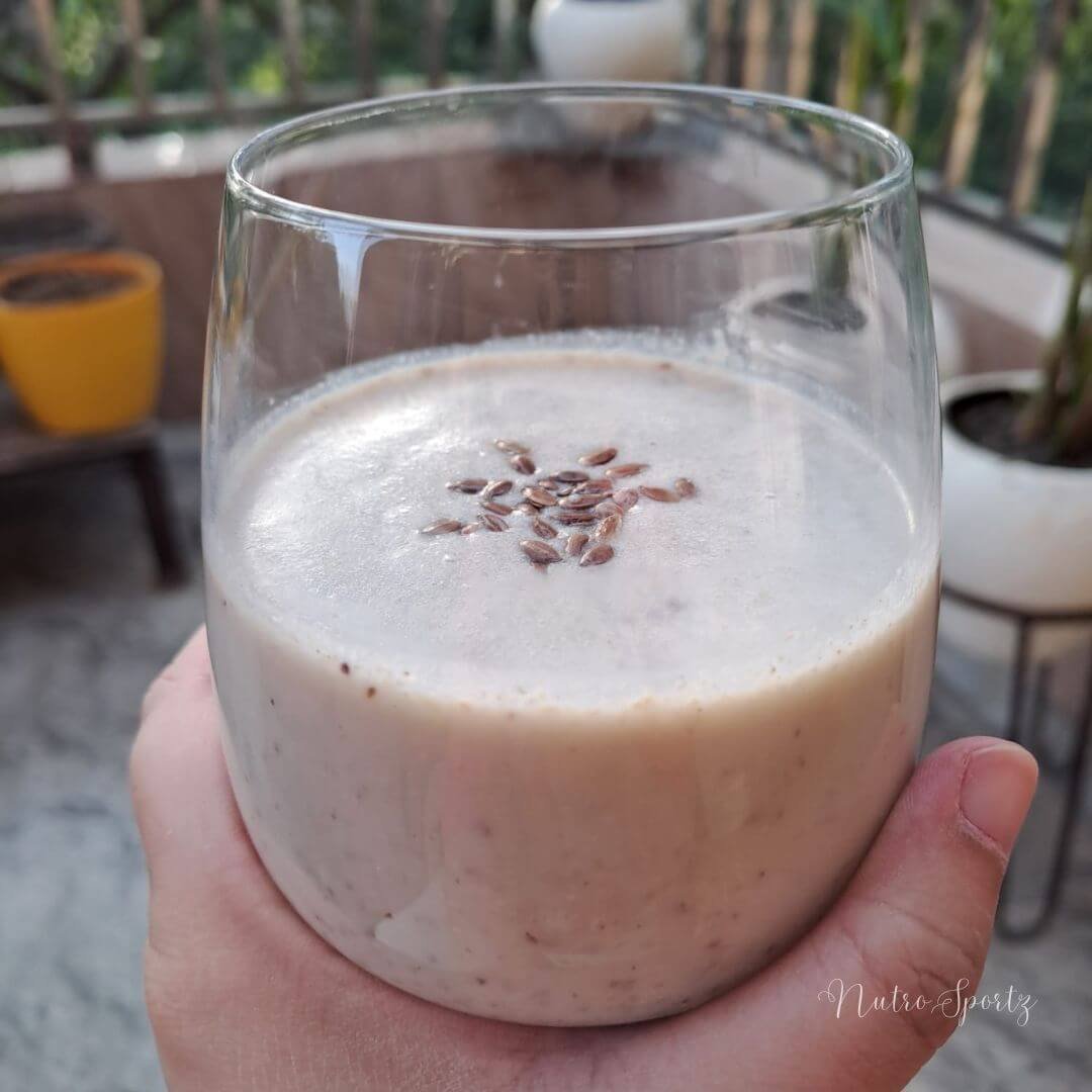 An image of banana shake with seeds in the glass.