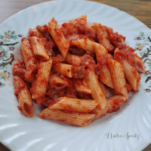 An image of red sauce pasta on a plate.
