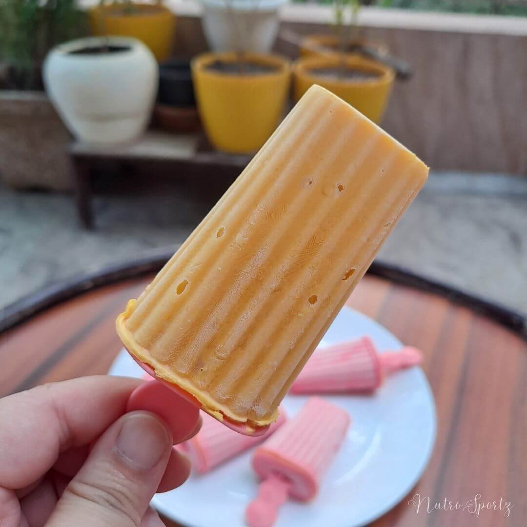 An image of mango frozen yogurt popsicle.