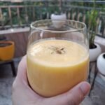 An image of mango milkshake in a glass.