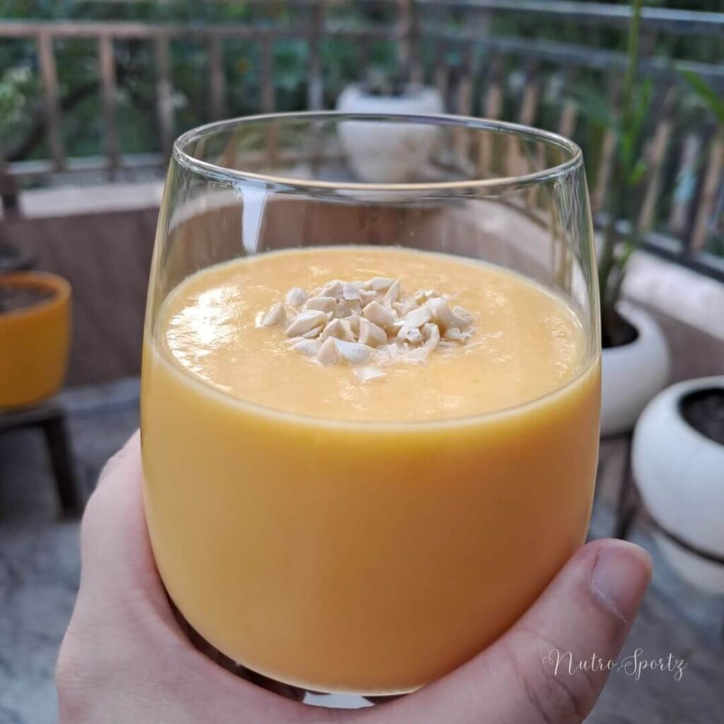 An image of a mango smoothie in a glass.